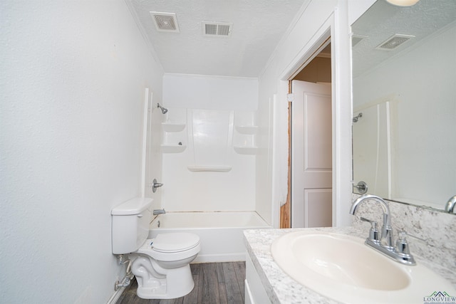 full bathroom featuring crown molding, a textured ceiling, toilet, vanity, and hardwood / wood-style flooring