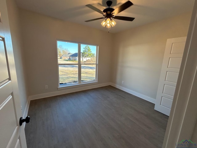 spare room featuring ceiling fan and dark hardwood / wood-style floors