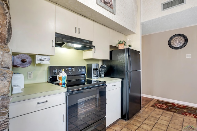 kitchen featuring black appliances, white cabinetry, a textured ceiling, and light tile patterned floors