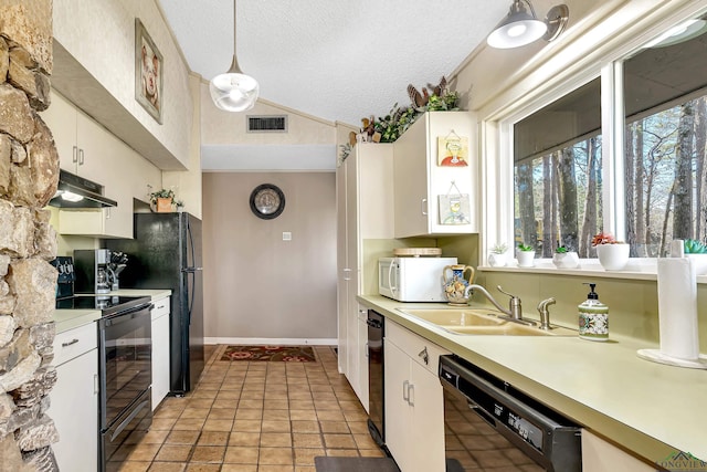 kitchen featuring black appliances, pendant lighting, white cabinetry, and sink