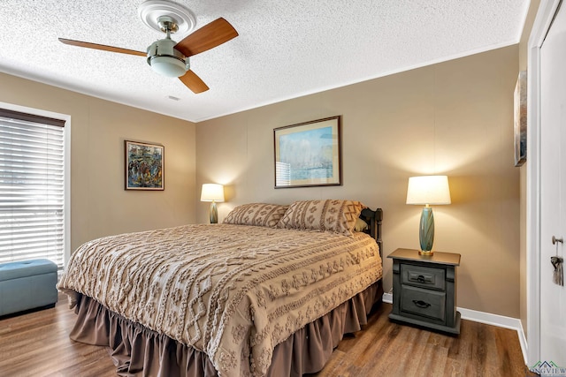 bedroom featuring a textured ceiling, ceiling fan, and hardwood / wood-style floors