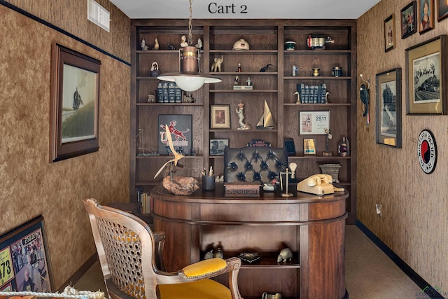 bar featuring built in shelves, carpet, and hanging light fixtures