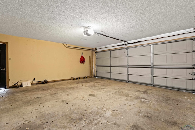 garage with a garage door opener and baseboards