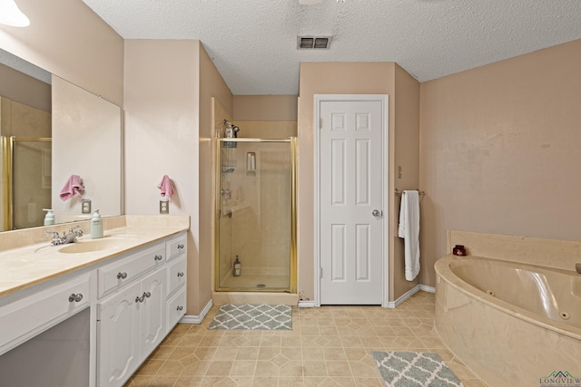 full bathroom with visible vents, a shower stall, and vanity