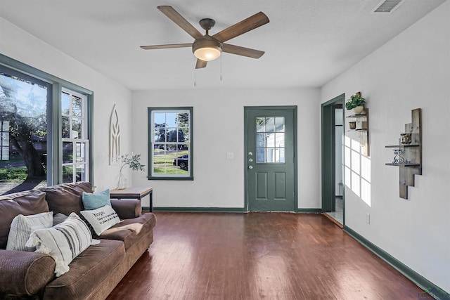 living room with ceiling fan and dark hardwood / wood-style floors