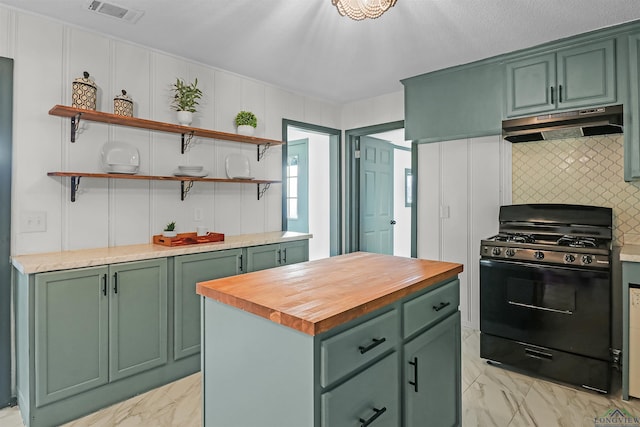 kitchen with gas stove, a center island, green cabinetry, and butcher block counters