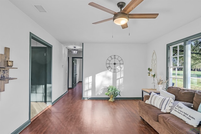 living room featuring ceiling fan and dark hardwood / wood-style floors