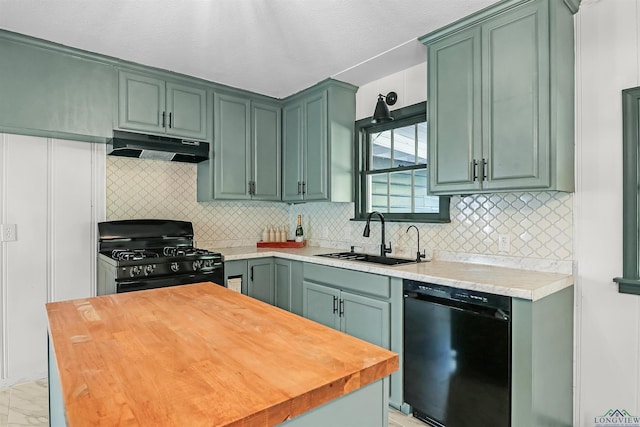 kitchen featuring decorative backsplash, sink, green cabinetry, and black appliances