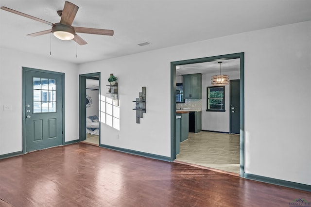 foyer entrance featuring dark hardwood / wood-style floors and ceiling fan