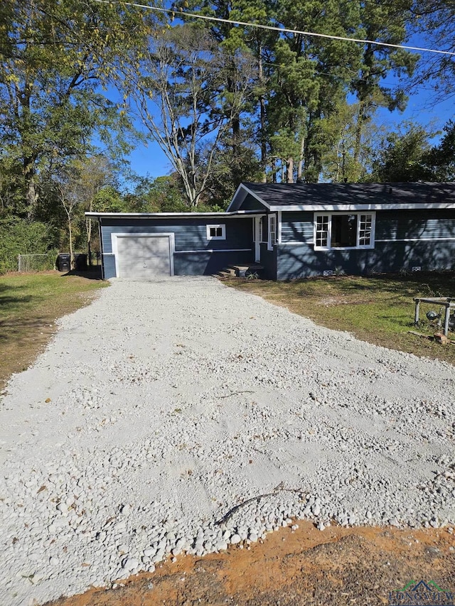 single story home with a front yard and a garage