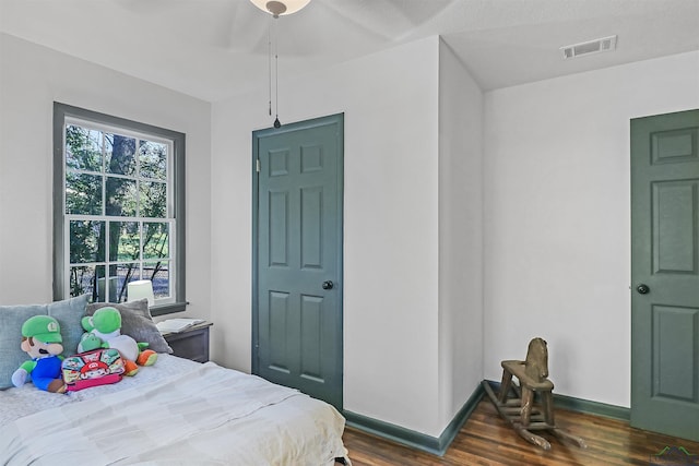 bedroom with ceiling fan and dark hardwood / wood-style floors