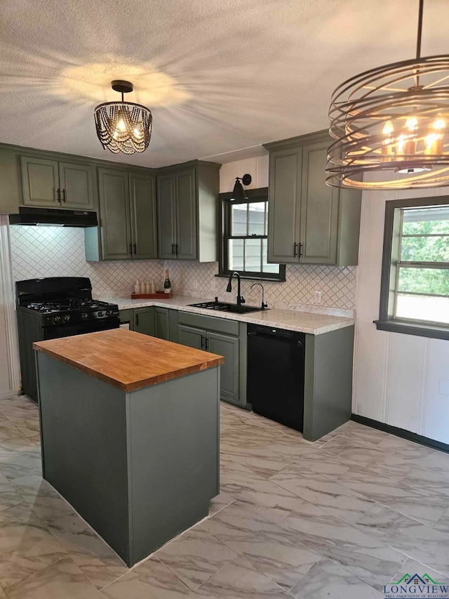 kitchen featuring wood counters, black appliances, sink, decorative light fixtures, and a kitchen island