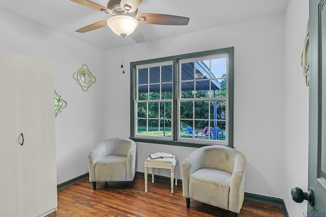 sitting room featuring dark hardwood / wood-style floors and ceiling fan