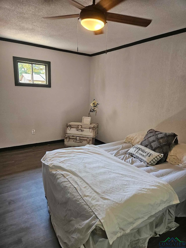 bedroom with a textured ceiling, ceiling fan, and dark hardwood / wood-style floors