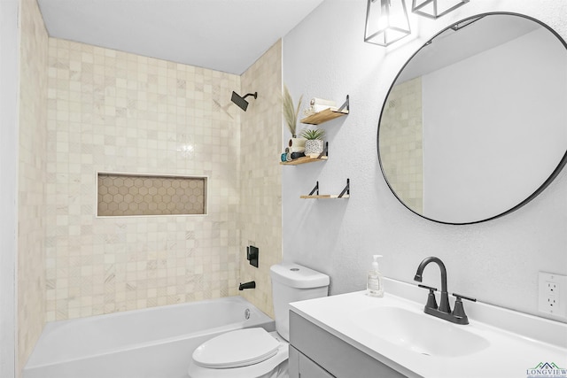 full bathroom featuring vanity, tiled shower / bath combo, and toilet