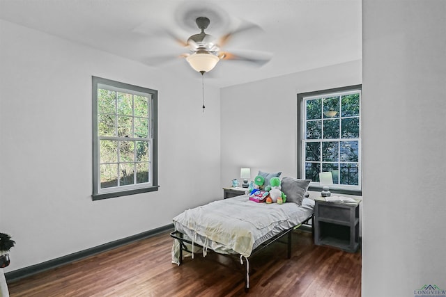 bedroom with dark hardwood / wood-style floors and ceiling fan