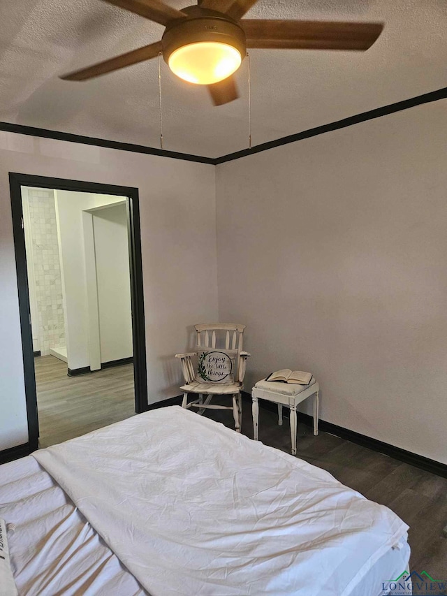 bedroom with hardwood / wood-style floors, a textured ceiling, and ceiling fan