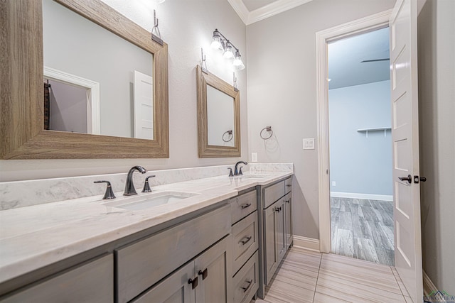 bathroom with crown molding and vanity