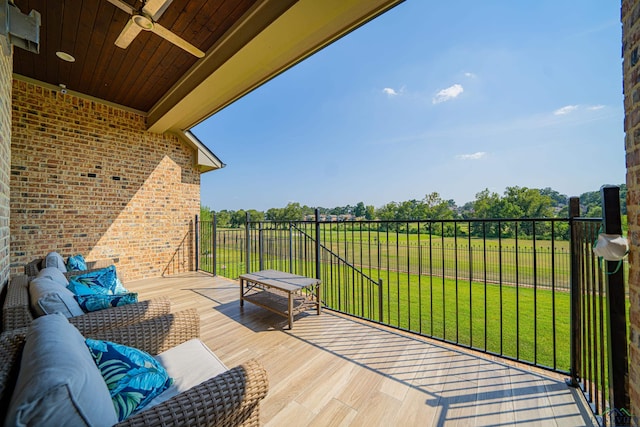 balcony with ceiling fan and an outdoor living space