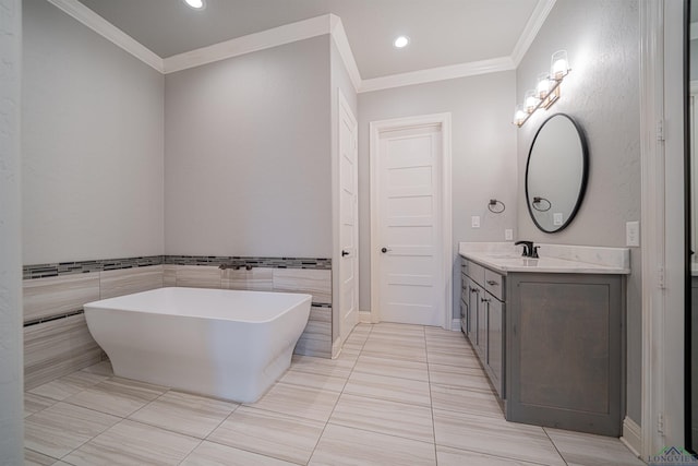 bathroom with vanity, a bath, tile patterned floors, ornamental molding, and tile walls