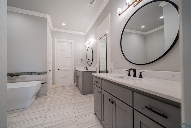 bathroom with tile patterned floors, a washtub, crown molding, and vanity