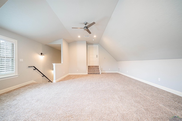 bonus room with ceiling fan, light colored carpet, and vaulted ceiling