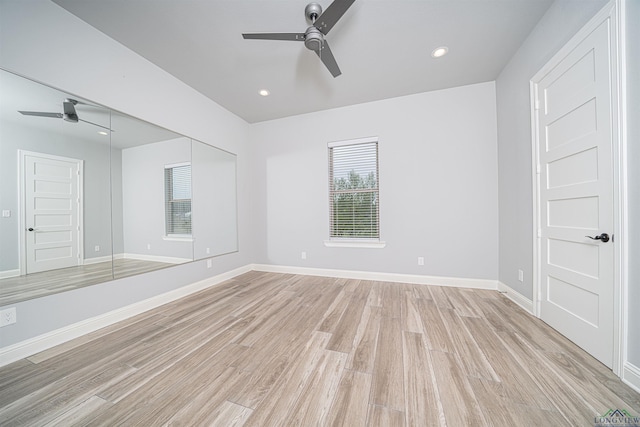 unfurnished bedroom featuring ceiling fan, light wood-type flooring, and a closet