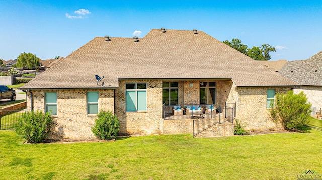 rear view of house with a patio area and a yard