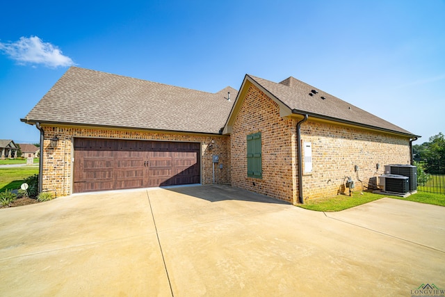 view of property exterior featuring a garage and central air condition unit