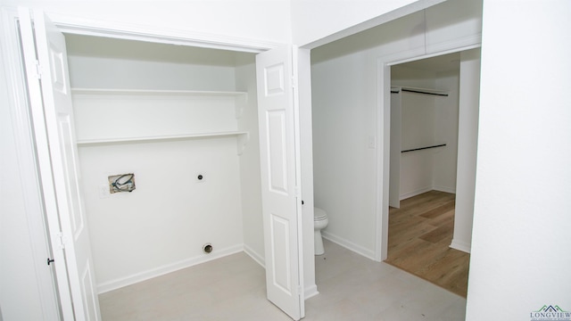 washroom with electric dryer hookup, laundry area, and baseboards