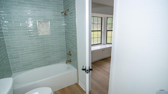 full bathroom featuring toilet, shower / bath combination, and wood finished floors