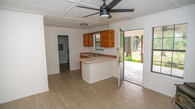 kitchen featuring light countertops, ceiling fan, baseboards, and light wood-style floors