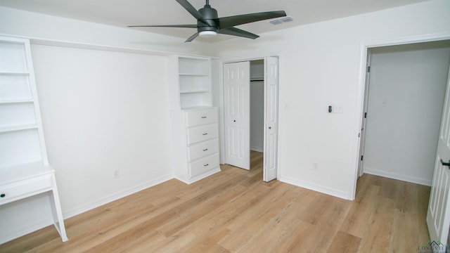 unfurnished bedroom featuring visible vents, light wood finished floors, baseboards, and a closet