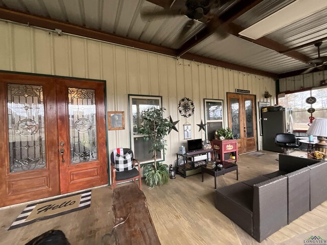 living room with beamed ceiling and light hardwood / wood-style flooring