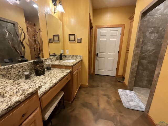 bathroom with a shower and vanity