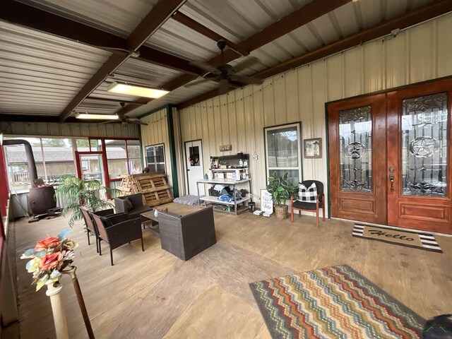 living room featuring ceiling fan, light hardwood / wood-style flooring, and french doors