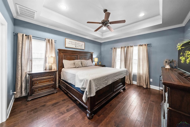 bedroom with a raised ceiling, ceiling fan, dark hardwood / wood-style flooring, and ornamental molding