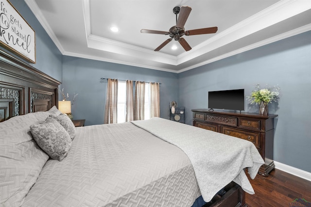 bedroom featuring ceiling fan, a raised ceiling, ornamental molding, and dark wood-type flooring