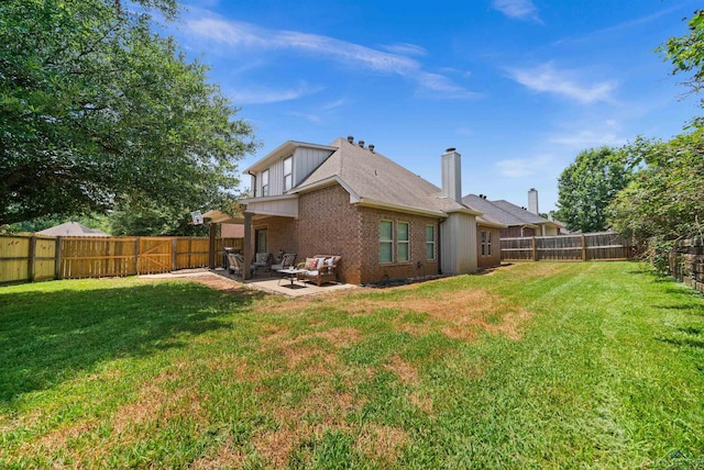 rear view of property featuring a lawn and a patio