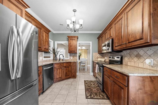 kitchen featuring an inviting chandelier, crown molding, light tile patterned floors, appliances with stainless steel finishes, and decorative light fixtures