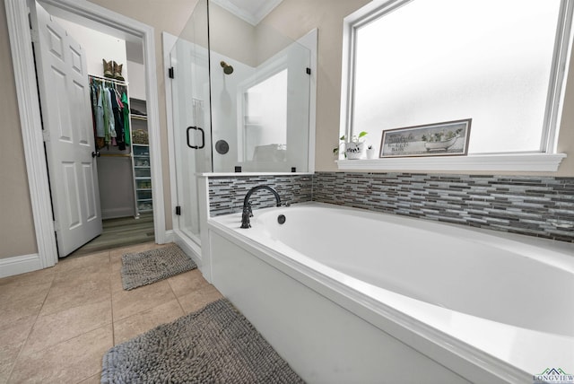 bathroom featuring tile patterned floors, ornamental molding, and shower with separate bathtub