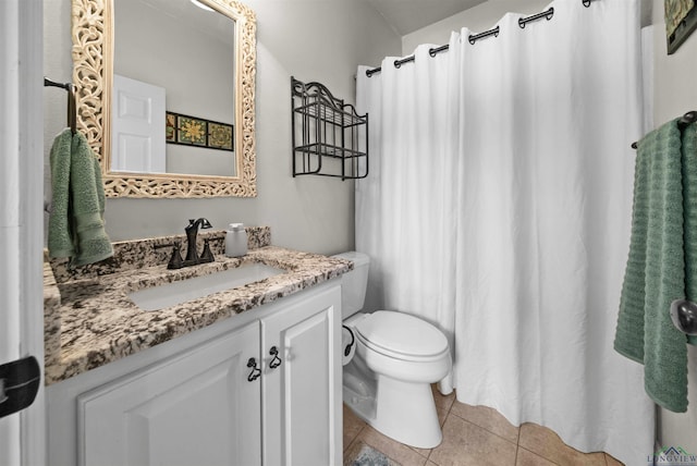 bathroom featuring tile patterned flooring, vanity, and toilet