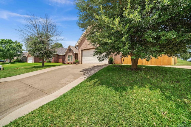 view of front of property featuring a garage and a front lawn