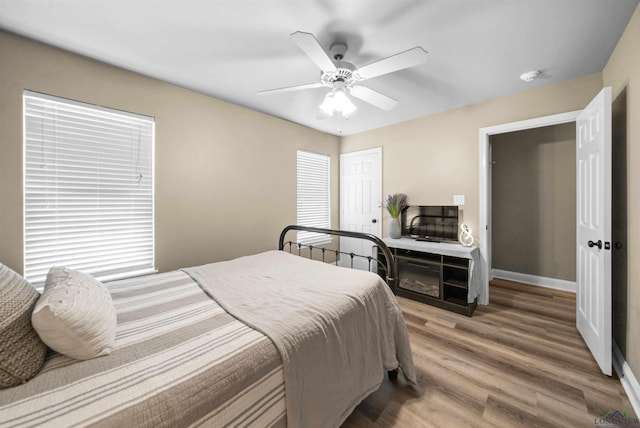 bedroom with hardwood / wood-style floors and ceiling fan