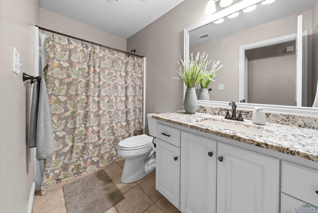 bathroom featuring toilet, vanity, and tile patterned floors