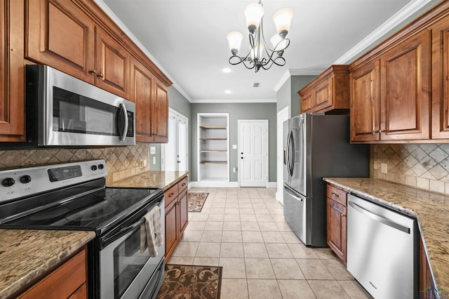 kitchen with light stone countertops, appliances with stainless steel finishes, ornamental molding, light tile patterned floors, and a notable chandelier