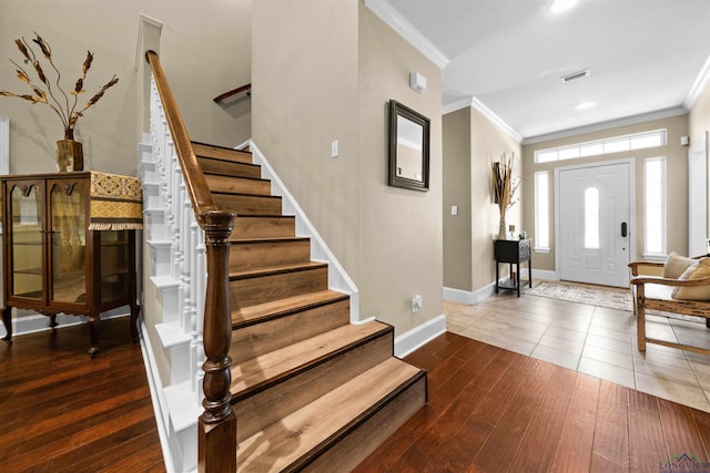 foyer entrance with wood-type flooring and crown molding