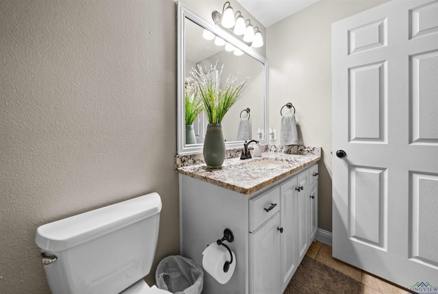 bathroom featuring tile patterned floors, vanity, and toilet