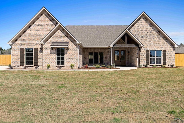 169 Andres Ln, Kilgore, TX 75662 - view of front facade with brick siding, a front yard, and fence