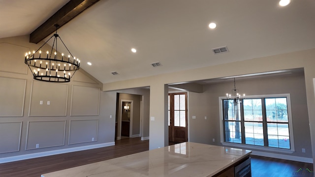 kitchen with light stone countertops, visible vents, lofted ceiling with beams, and an inviting chandelier